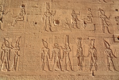 brown concrete wall with human face carved